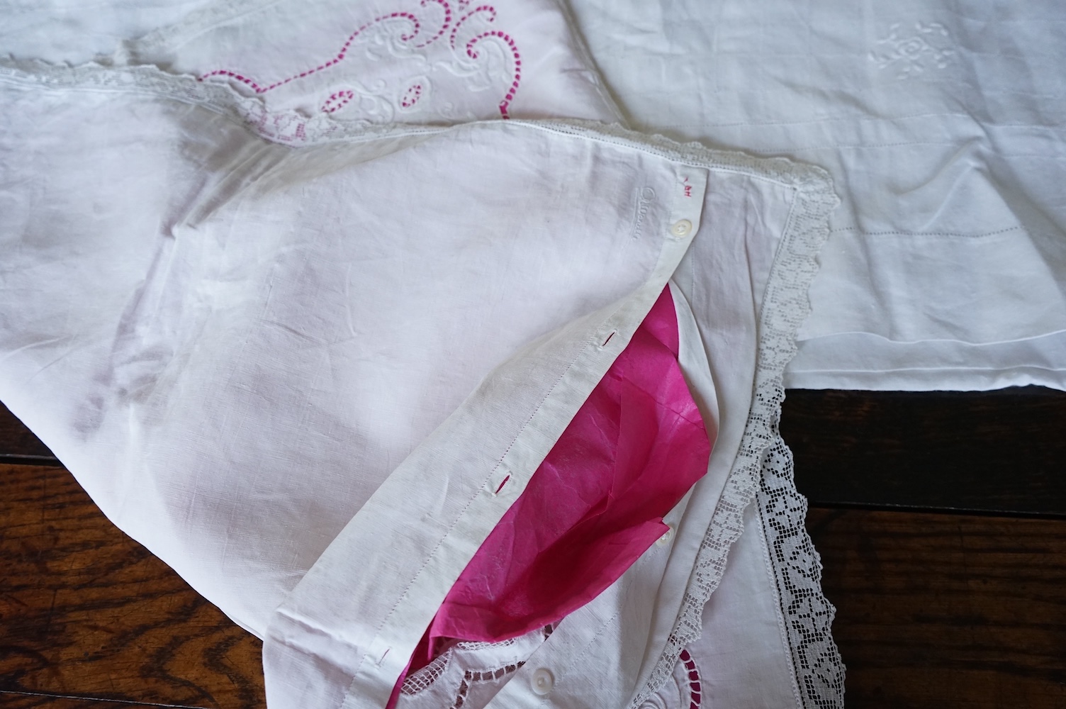 A late 19th century early 20th century finely woven, hand worked linen sheet 6’8”wide, together with a near matching large square pillowcase. Both items worked in Embroidery Anglaise, button holed and inset and trimmed w